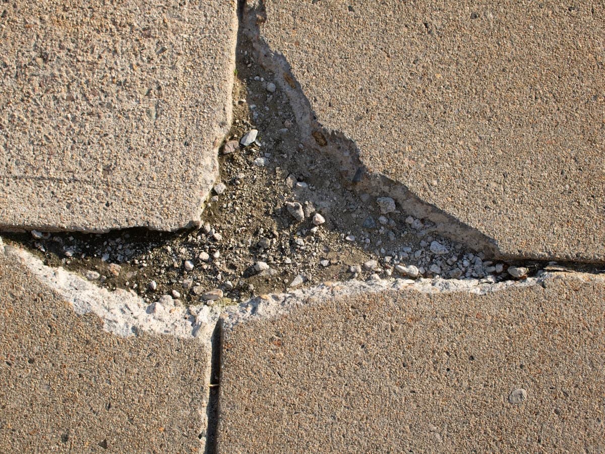 A broken, spalled section of concrete slab in need of repair